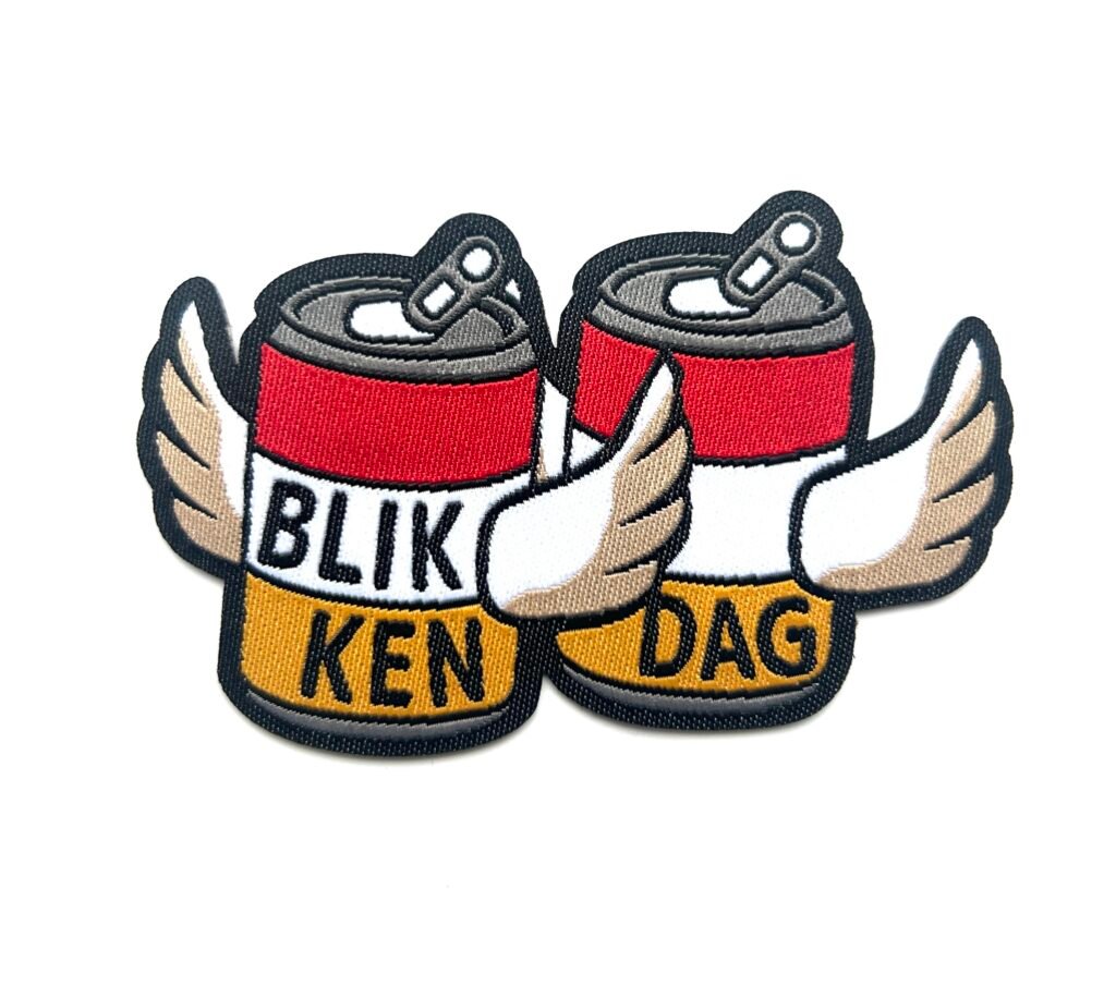 Blikkendag Oeteldonk embleem met twee blikken met vleugels van 7 x 5 cm op carnavalsjas